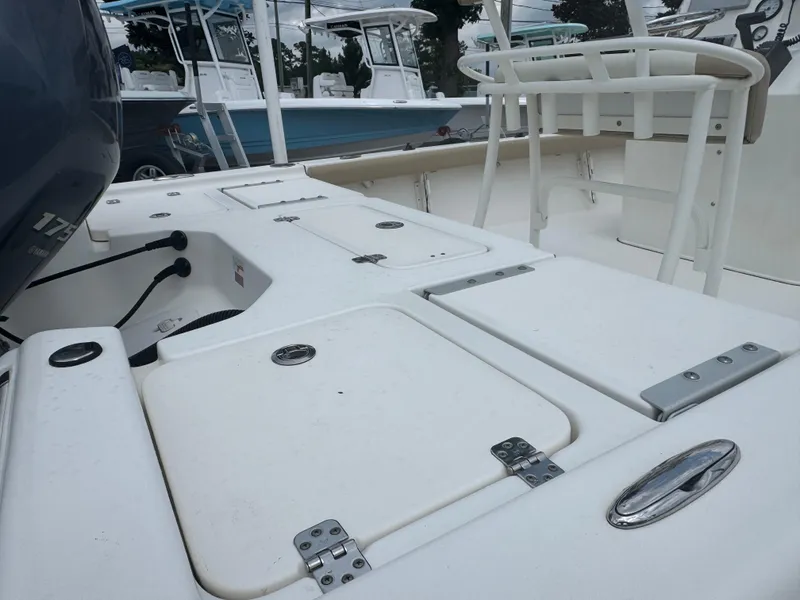 Slide: The Image of 2016 Key West 210BR boat deck with storage compartments and seating. - 4