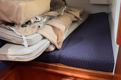 Slide: The Image of 2003 Caliber 40LRC interior cabin with stacked cushions and bedding. - 11