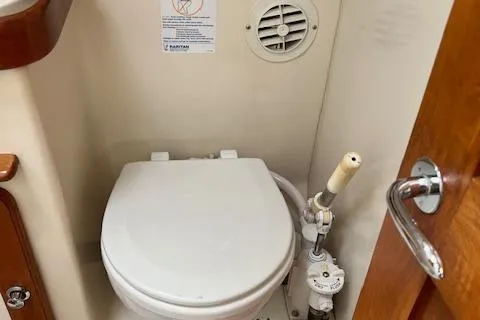 Slide: The Image of 2003 Caliber 40LRC marine toilet with manual pump and ventilation. - 13