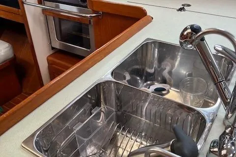 Slide: The Image of Kitchen sink area in a 2003 Caliber 40LRC yacht, featuring stainless steel fixtures. - 30