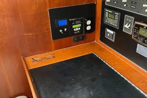 Slide: The Image of Control panel of a 2003 Caliber 40LRC sailboat with wooden finish and navigation equipment. - 32