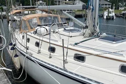 Slide: The Image of 2003 Caliber 40LRC sailboat docked at a marina, featuring a sleek design and spacious deck. - 4