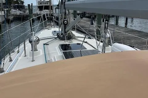 Slide: The Image of 2003 Caliber 40LRC sailboat docked, featuring deck and solar panels. - 6