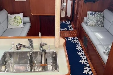 Slide: The Image of Interior of 2003 Caliber 40LRC yacht with modern kitchen and cozy seating area. - 8