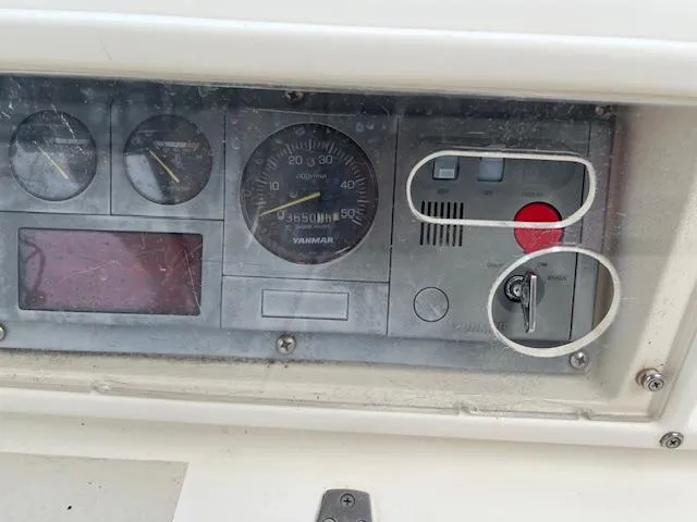 Slide: The Image of Control panel of a 2003 Caliber 40LRC boat with gauges and ignition key. - 9