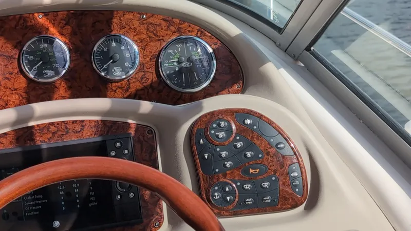 Slide: The Image of Dashboard of a 2007 Sea Ray 340 Sundancer boat with gauges and controls. - 10