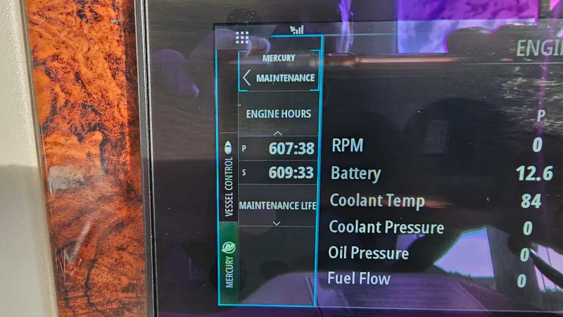 Slide: The Image of Display screen of a 2007 Sea Ray 340 Sundancer showing engine hours and maintenance data. - 16