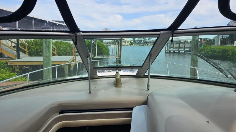 Slide: The Image of 2007 Sea Ray 340 Sundancer cockpit view with marina backdrop. - 21