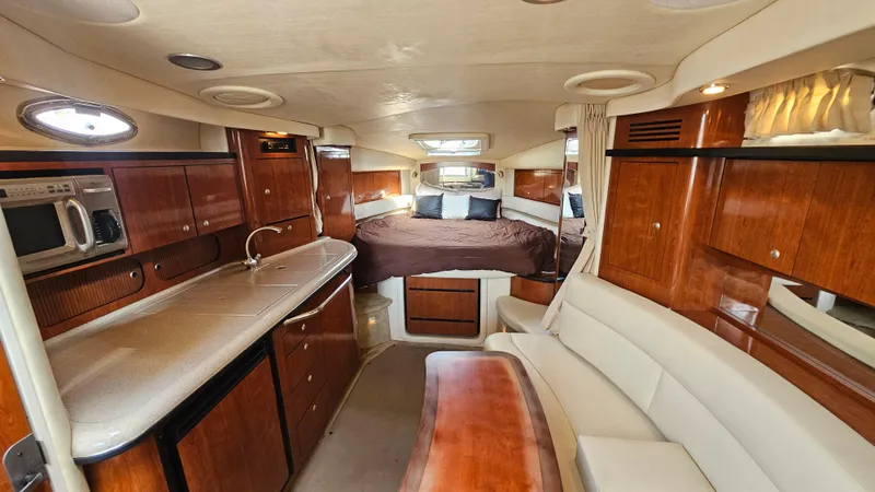 Slide: The Image of Luxurious interior of 2007 Sea Ray 340 Sundancer yacht with kitchen and sleeping area. - 22