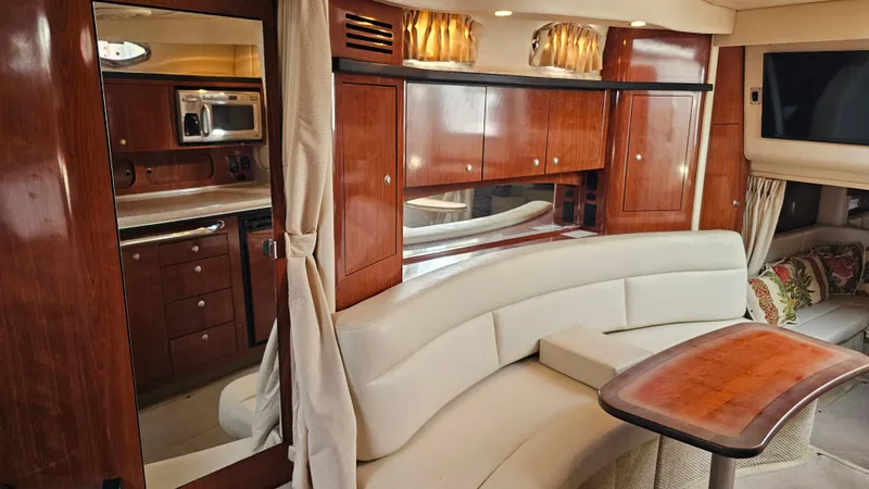 Slide: The Image of Luxurious interior of 2007 Sea Ray 340 Sundancer with wood cabinetry and plush seating. - 23