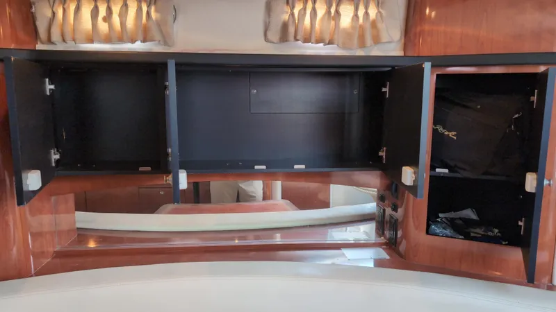 Slide: The Image of Open cabinets inside a 2007 Sea Ray 340 Sundancer yacht, showcasing interior storage space. - 25