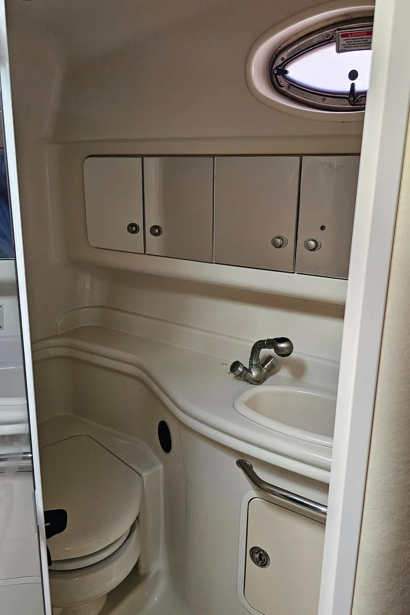 Slide: The Image of 2007 Sea Ray 340 Sundancer bathroom with sink, toilet, and storage cabinets. - 26