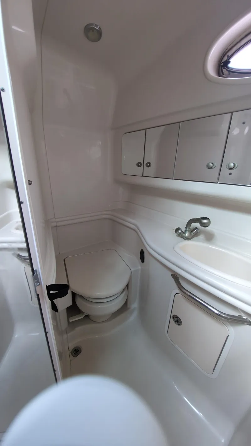 Slide: The Image of 2007 Sea Ray 340 Sundancer bathroom with sink, toilet, and storage cabinets. - 27