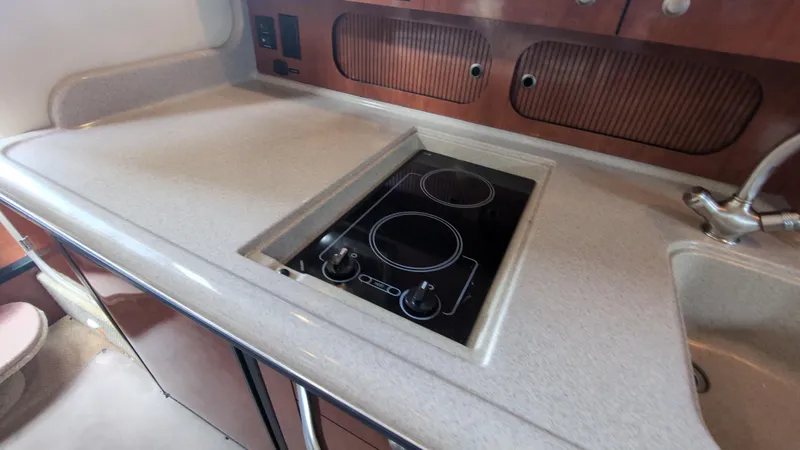 Slide: The Image of 2007 Sea Ray 340 Sundancer kitchen with electric stove and sink. - 29