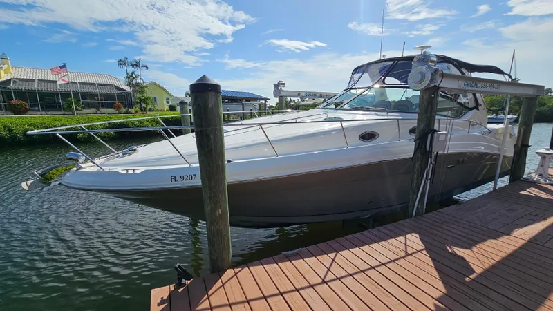 Slide: The Image of 2007 Sea Ray 340 Sundancer docked at marina under clear blue sky. - 3