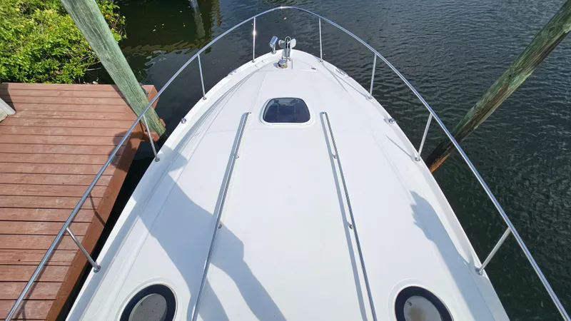 Slide: The Image of 2007 Sea Ray 340 Sundancer boat docked, viewed from above, showing deck and railing. - 36