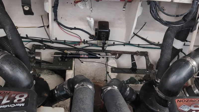 Slide: The Image of Engine compartment of a 2007 Sea Ray 340 Sundancer with visible hoses and wiring. - 48