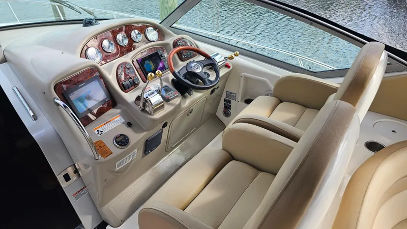 Slide: The Image of 2007 Sea Ray 340 Sundancer helm with beige seats and advanced navigation controls. - 7