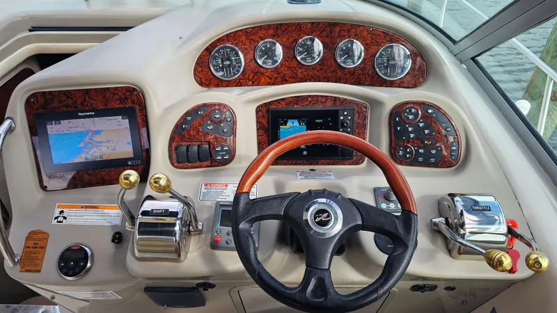 Slide: The Image of 2007 Sea Ray 340 Sundancer helm with navigation screens and controls. - 8