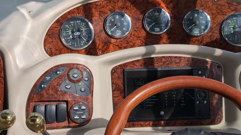 Slide: The Image of Dashboard of a 2007 Sea Ray 340 Sundancer boat with wood accents and gauges. - 9