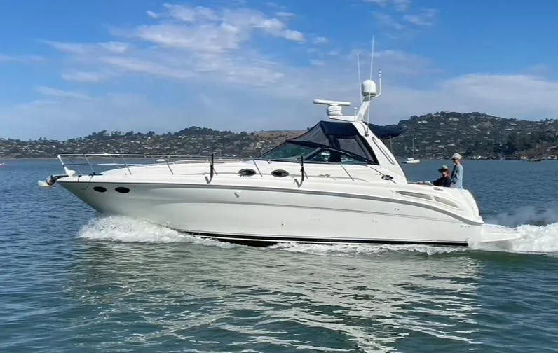 The Image of 2000 Sea Ray 380 Sundancer cruising on a calm lake under a clear blue sky. - 0