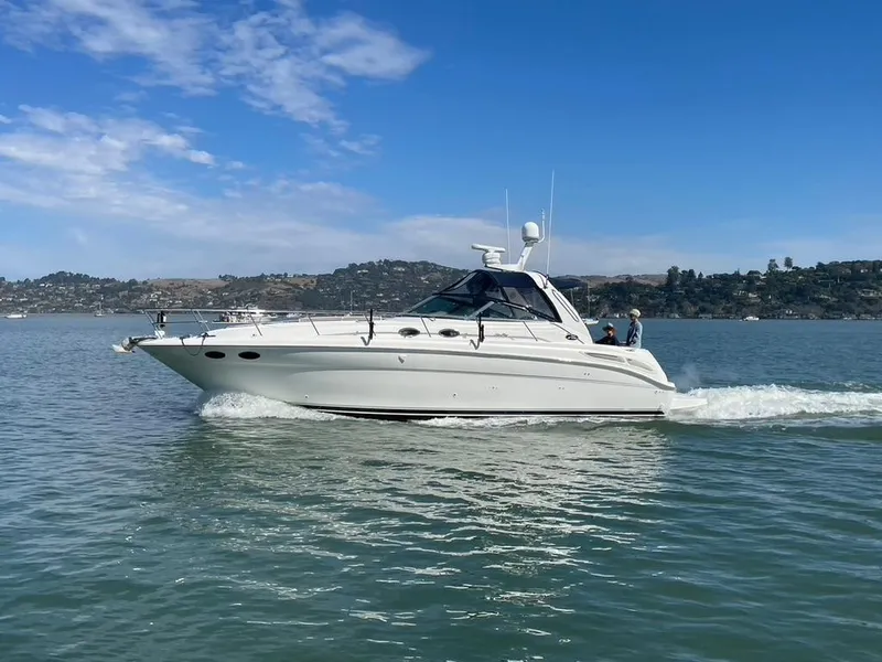 Slide: The Image of 2000 Sea Ray 380 Sundancer cruising on calm waters under a clear blue sky. - 1