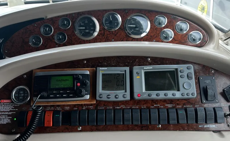Slide: The Image of Control panel of a 2000 Sea Ray 380 Sundancer boat with gauges and navigation equipment. - 11