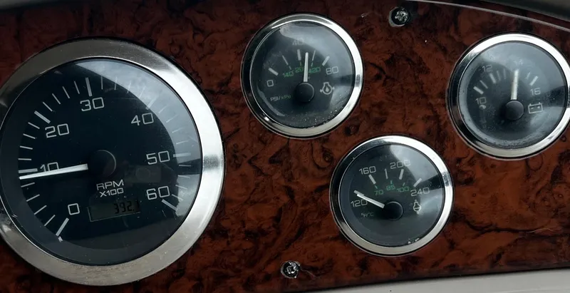 Slide: The Image of Dashboard gauges of a 2000 Sea Ray 380 Sundancer boat. - 13