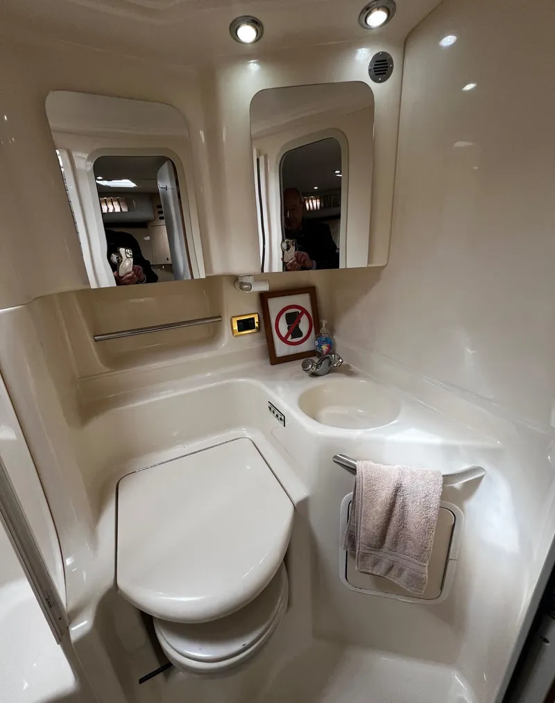 Slide: The Image of Interior of 2000 Sea Ray 380 Sundancer bathroom with modern fixtures and lighting. - 17