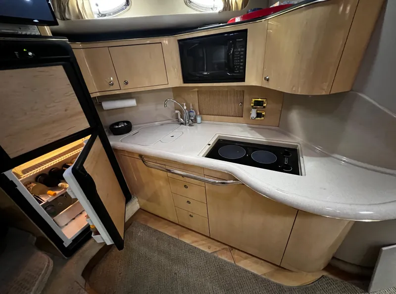Slide: The Image of Interior of a 2000 Sea Ray 380 Sundancer yacht kitchen with fridge, stove, and microwave. - 22