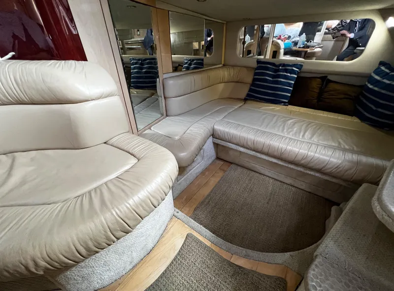 Slide: The Image of Luxurious interior of 2000 Sea Ray 380 Sundancer with beige leather seating and striped pillows. - 24