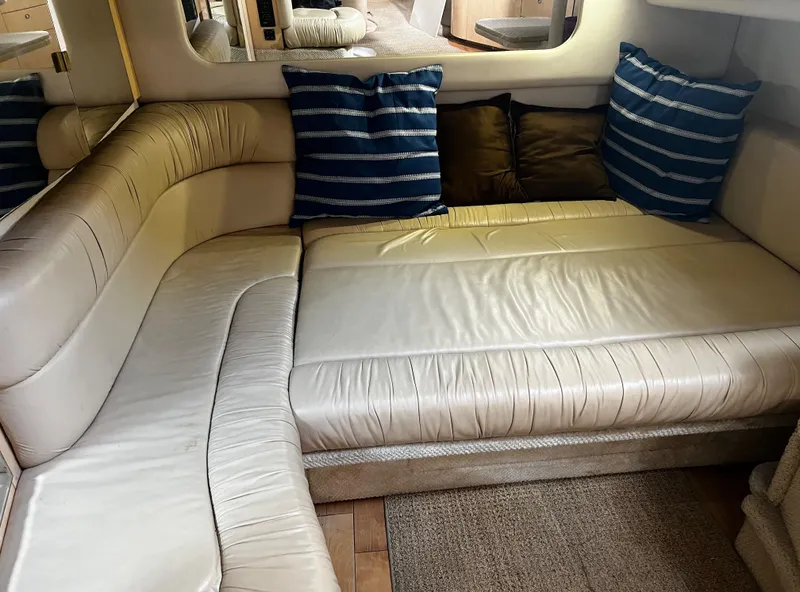 Slide: The Image of Interior of 2000 Sea Ray 380 Sundancer with cream leather seating and striped cushions. - 25