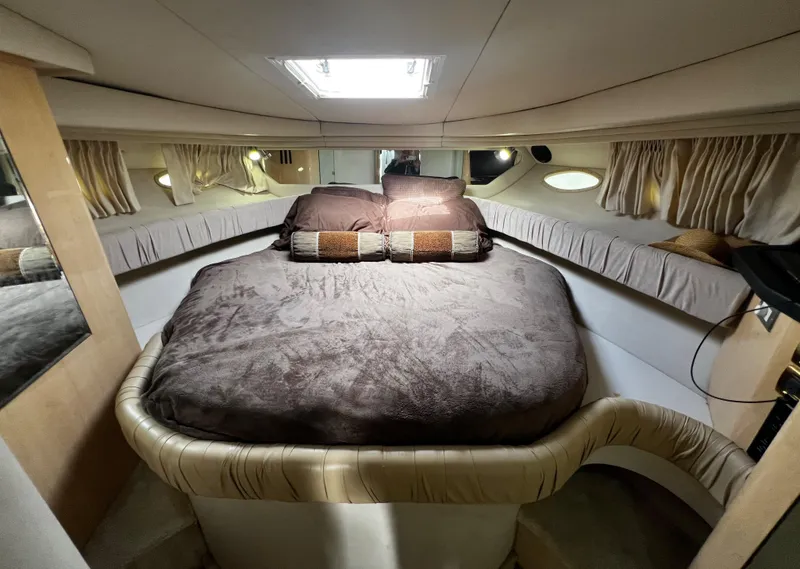Slide: The Image of Luxurious cabin interior of 2000 Sea Ray 380 Sundancer with cozy bed and elegant decor. - 26