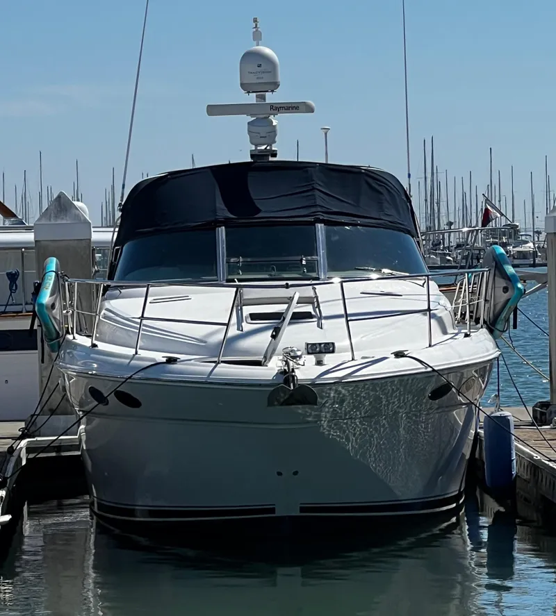 Slide: The Image of 2000 Sea Ray 380 Sundancer docked at marina, front view. - 7