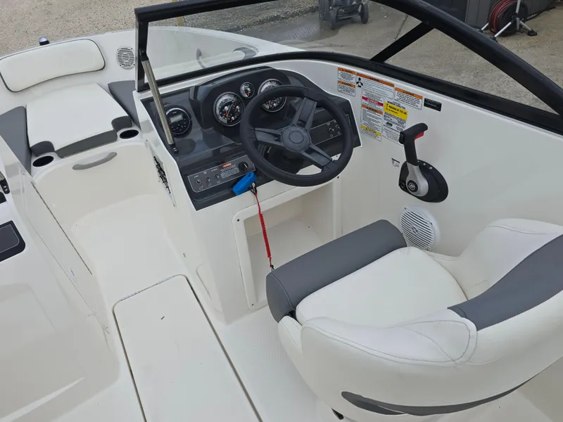 Slide: The Image of 2018 Bayliner VR4 Bowrider I/O cockpit with steering wheel and control panel. - 16