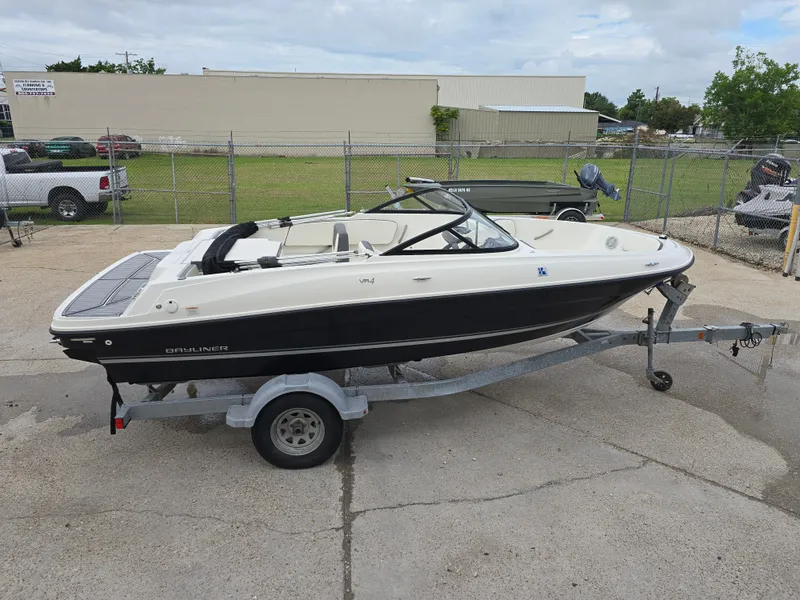 Slide: The Image of 2018 Bayliner VR4 Bowrider I/O on trailer, parked outdoors. - 4