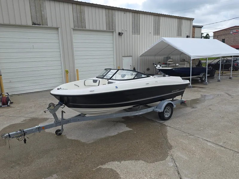 Slide: The Image of 2018 Bayliner VR4 Bowrider I/O on trailer, parked outside a garage. - 7