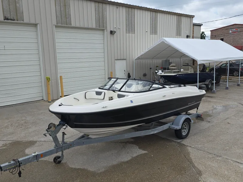 Slide: The Image of 2018 Bayliner VR4 Bowrider I/O on trailer, parked outside a warehouse. - 9
