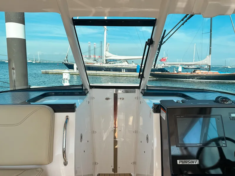 Slide: The Image of 2018 Pursuit DC 325 Dual Console boat interior with marina view. - 21