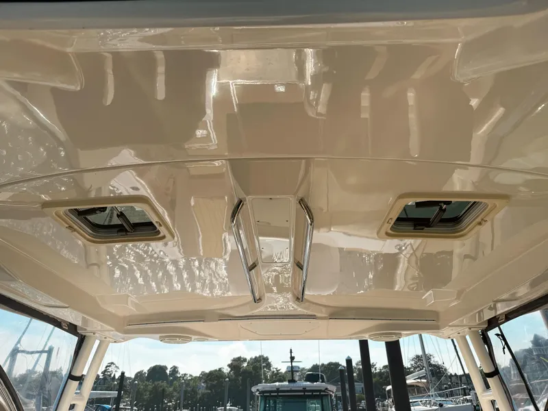 Slide: The Image of 2018 Pursuit DC 325 Dual Console boat ceiling with hatches and sleek design. - 33