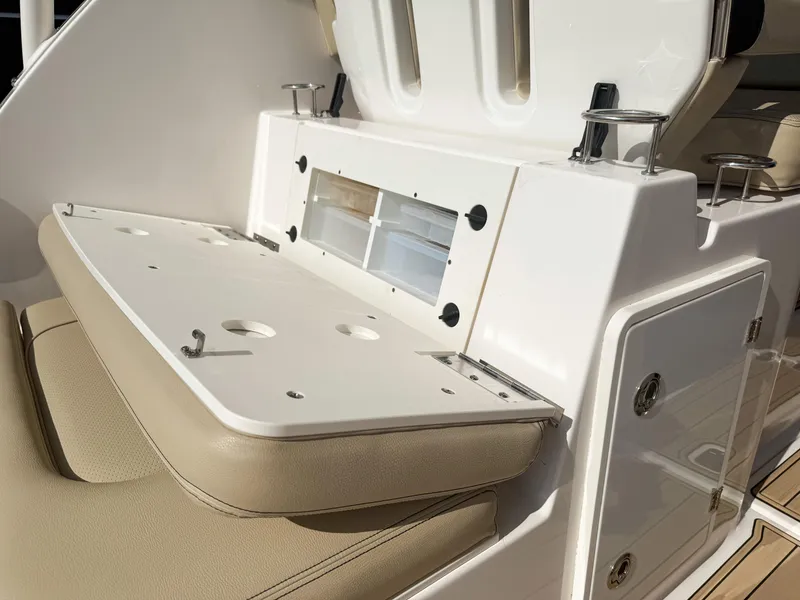 Slide: The Image of 2018 Pursuit DC 325 Dual Console boat interior with seating and storage compartments. - 45