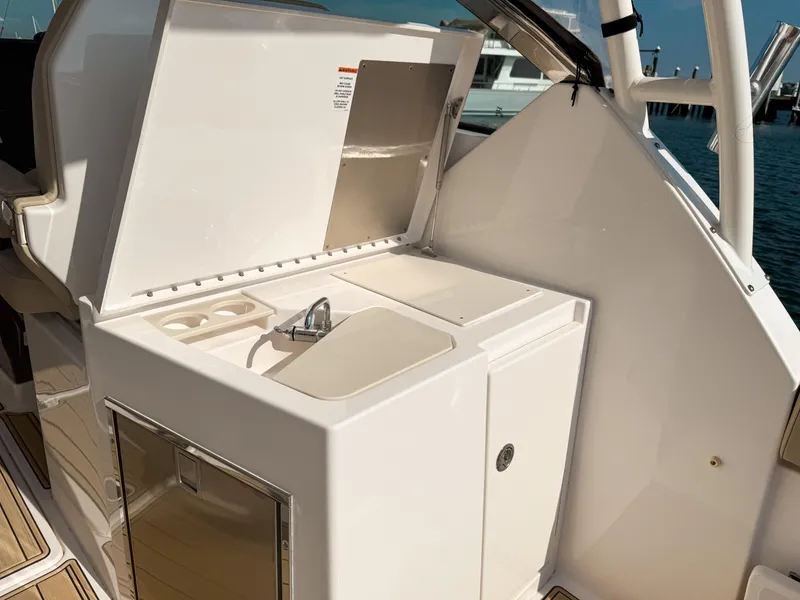 Slide: The Image of 2018 Pursuit DC 325 Dual Console boat with open sink and storage area. - 49