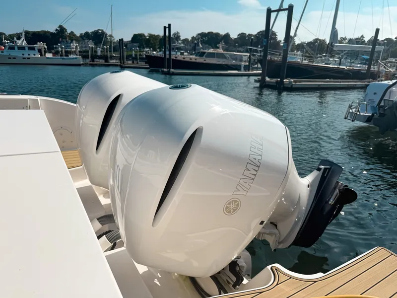 Slide: The Image of 2018 Pursuit DC 325 Dual Console with Yamaha outboard engines docked at marina. - 6