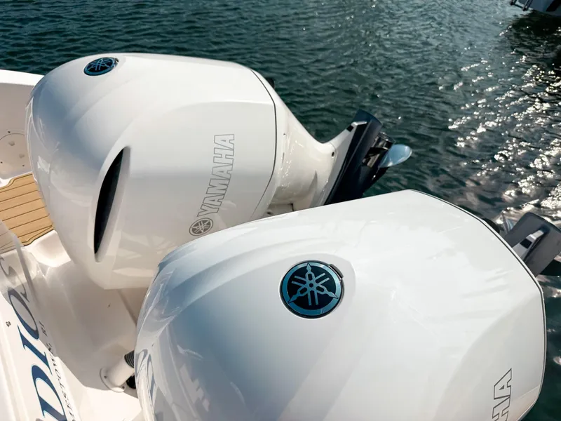 Slide: The Image of 2018 Pursuit DC 325 Dual Console with Yamaha outboard engines on water. - 8