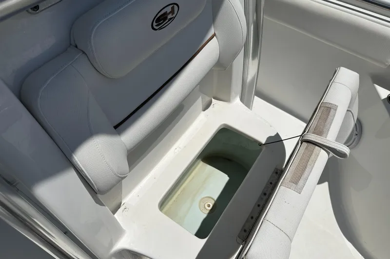 Slide: The Image of 2019 Sea Hunt Ultra 225 boat seat with storage compartment open. - 12