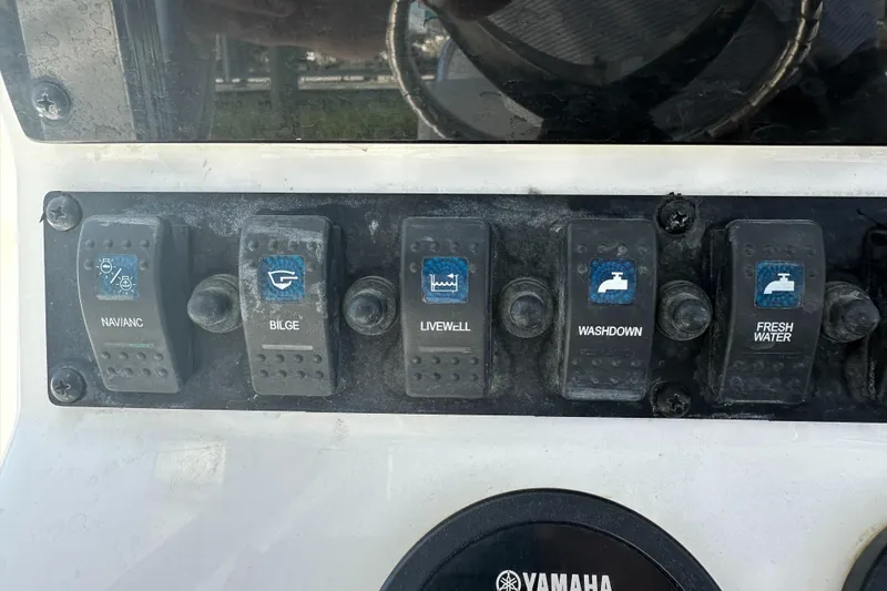 Slide: The Image of Control panel of a 2019 Sea Hunt Ultra 225 boat with labeled switches. - 16