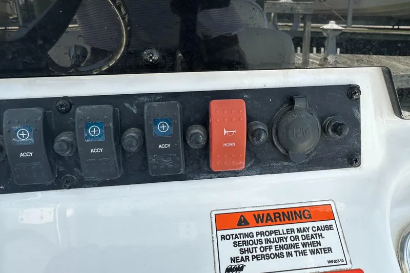 Slide: The Image of Control panel of a 2019 Sea Hunt Ultra 225 boat with horn and accessory switches. - 18
