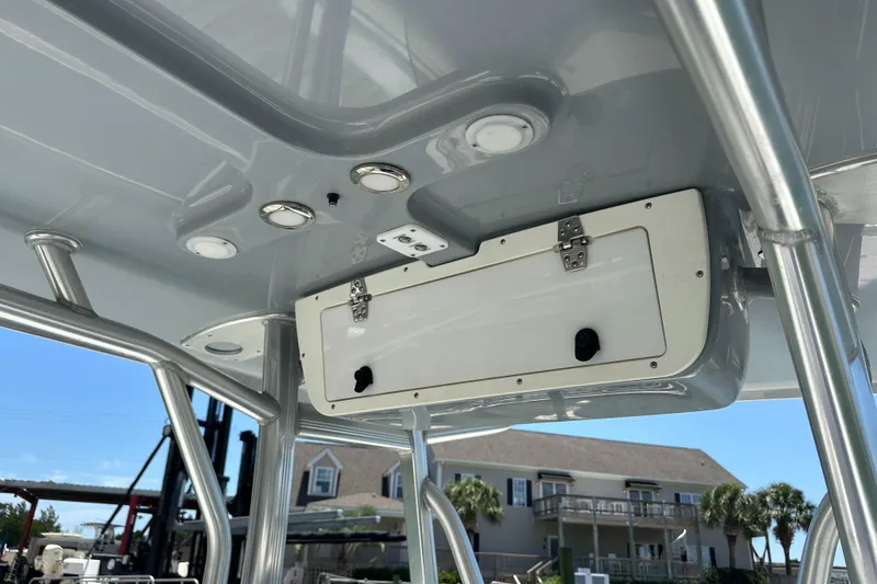 Slide: The Image of 2019 Sea Hunt Ultra 225 boat interior with storage compartment and lighting. - 20