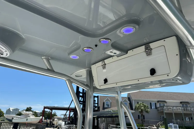 Slide: The Image of 2019 Sea Hunt Ultra 225 boat T-top with LED lights and storage compartment. - 21