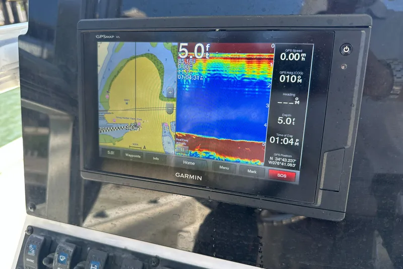 Slide: The Image of Garmin GPS display on 2019 Sea Hunt Ultra 225, showing navigation and depth information. - 23